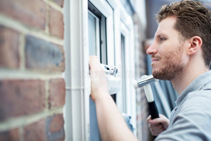 Construction Worker Installing New Windows In House stock images