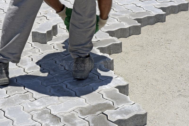 Construction worker laying concrete tiles royalty free stock images