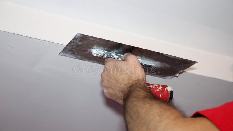 Construction Worker Plastering Ceiling With Work Tool stock photos