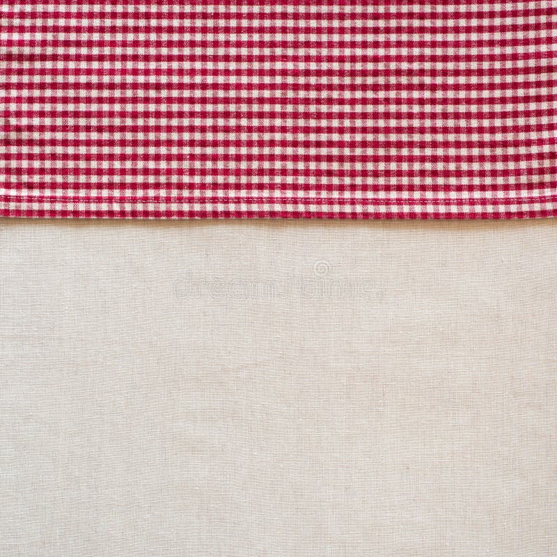 Country Style Red and White Checked Cloth Napkin along side of Off White Linen Tablecloth as blank Background with room or space f stock images