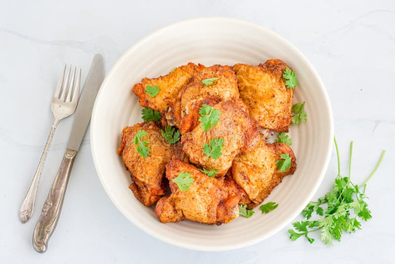 Crispy Oven Fried Chicken Thighs Garnished with Cilantro, Top Down Photo royalty free stock photo