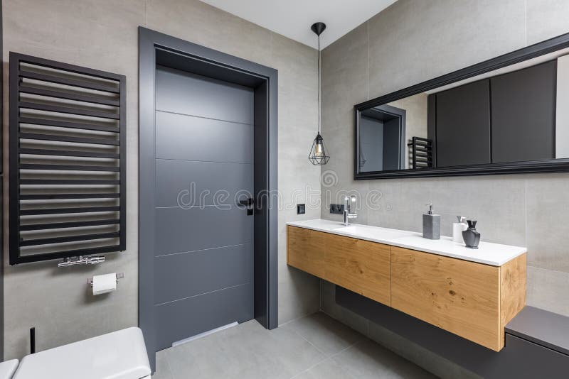 Dark bathroom with countertop basin. Dark and elegant bathroom with countertop basin and mirror stock photo