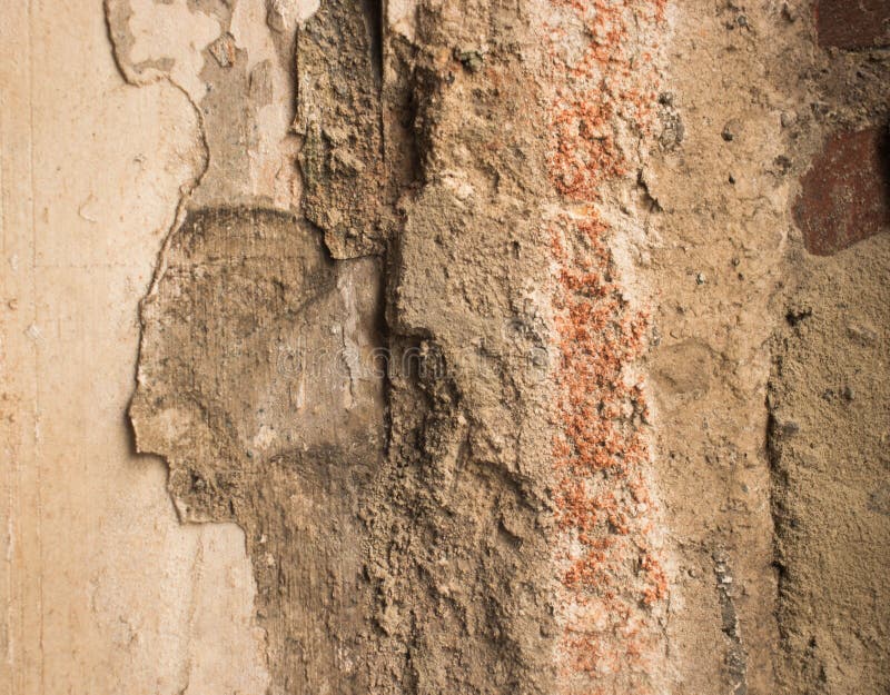 Decayed plastered surface of the facade of the house. The appearance of the roughly plastered surface of the facade of the house,decayed plastered surfac royalty free stock image