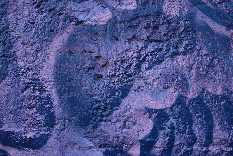 Decorative relief plaster. Dark deep blue and violet painted relief wall with rough chaotic convex elements. Texture of concrete wall covered uneven decorative stock photo