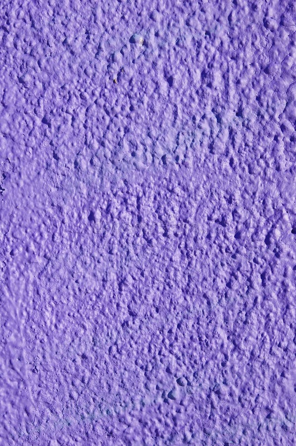 Decorative relief purple plaster on wall. Closeup stock photography