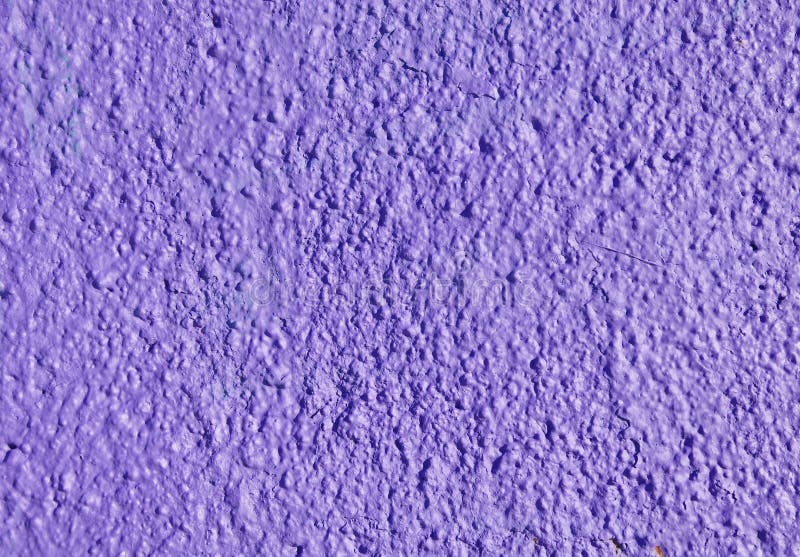 Decorative relief purple plaster on wall. Closeup stock photography