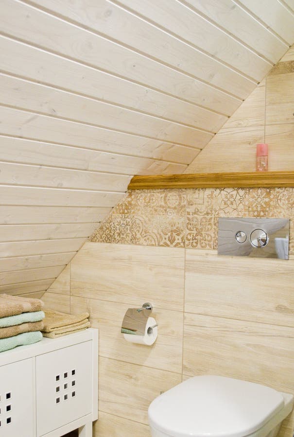 Loft bathroom with wooden ceiling detail. Detail of a cozy bathroom in a home, loft room with wooden or timber planks on the ceiling. Elegant interior design stock photos