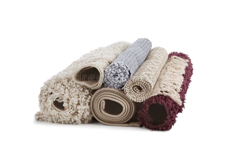 Different rolled carpets on white background stock images