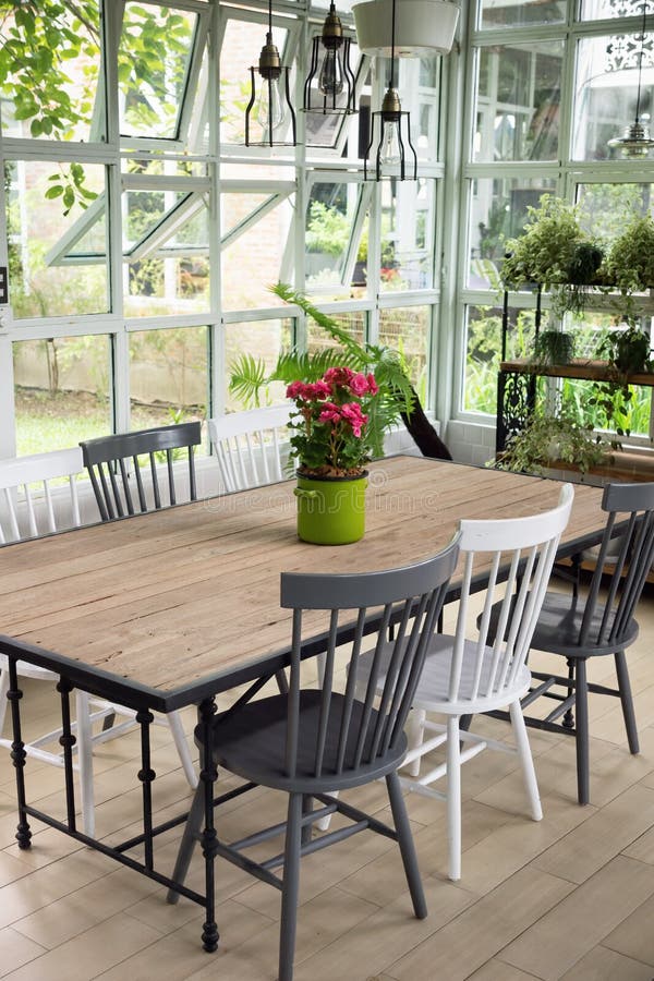 Dining room interior with table, chairs and plants against big w stock photography