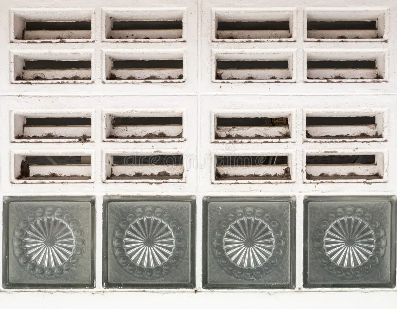 Dirty air ventilation grille. Dirty air ventilation grille with the glass box on the public toilet wall stock photography