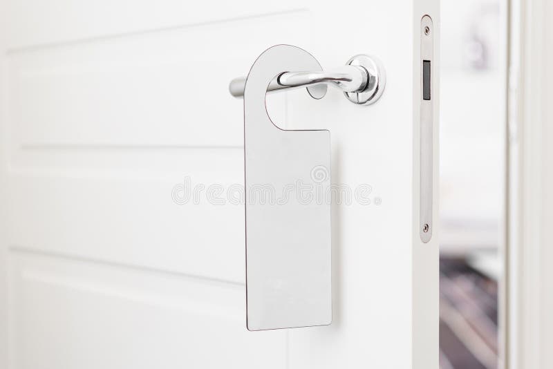 Door knob with empty label on a door handle for your text. Empty white flyer mockup hang on door handle. Leaflet design. On entrance doorknob. Dont disturb sign stock images