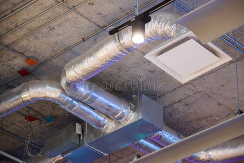 Ducts elements on ceiling ventilation system. stock image