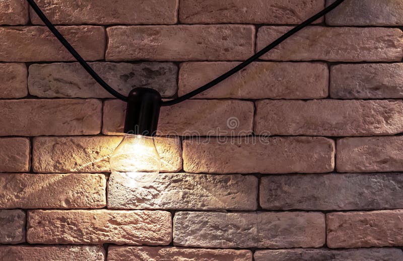 Electric lamp on a brick wall background. Loft style interior royalty free stock photo