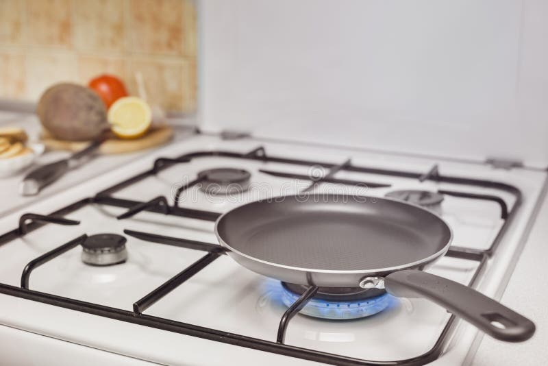 Empty pan on the stove. Burning flame royalty free stock images