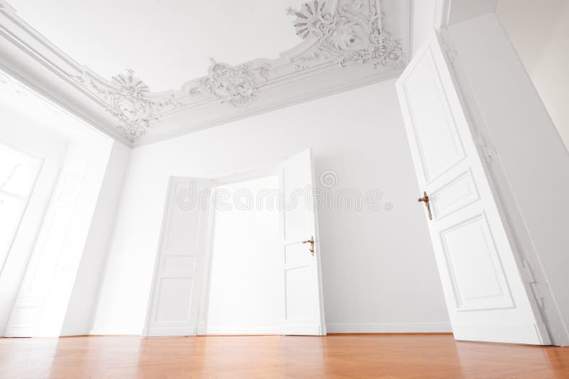 Empty room in luxury apartment flat with wooden floor and stucco ceiling.  stock photo