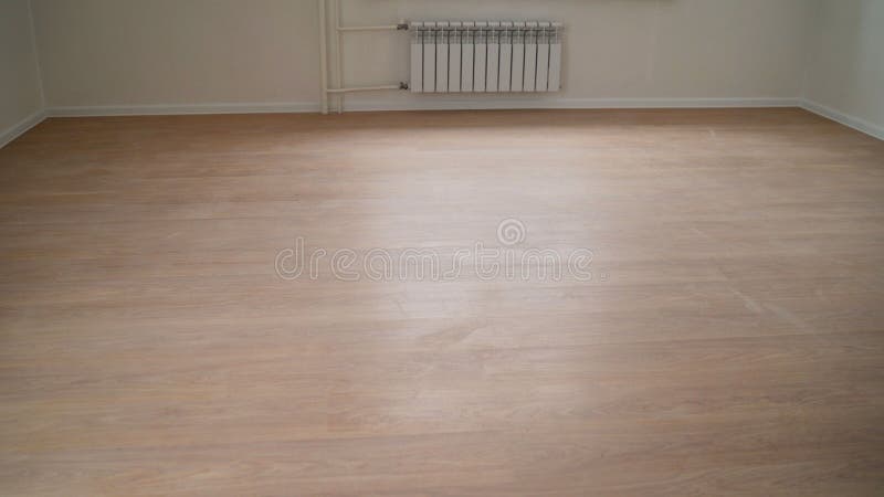 Empty room after renovation- two windows, white walls and wooden floor in new apartment. New laminate in a new apartment stock images