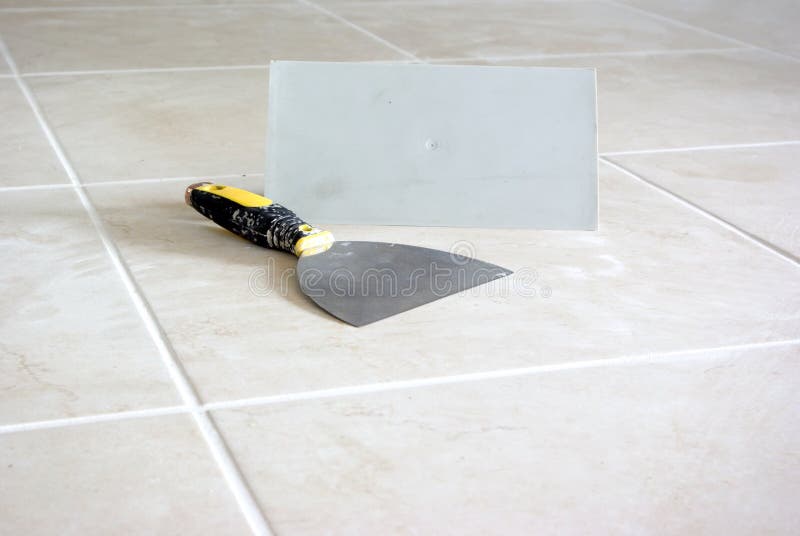 End of tiling. Tiling equipments on shiny new floor royalty free stock photo