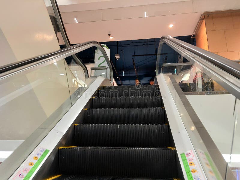 Escalator go up to second floor at Robinson department store stock photo