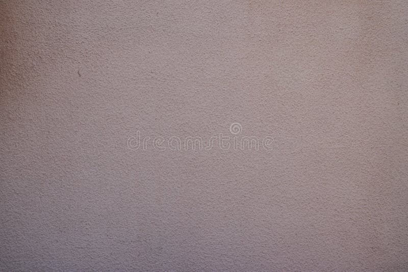 Exterior building wall facade plastered pink painted background texture. An Exterior building wall facade plastered pink painted background texture royalty free stock photo
