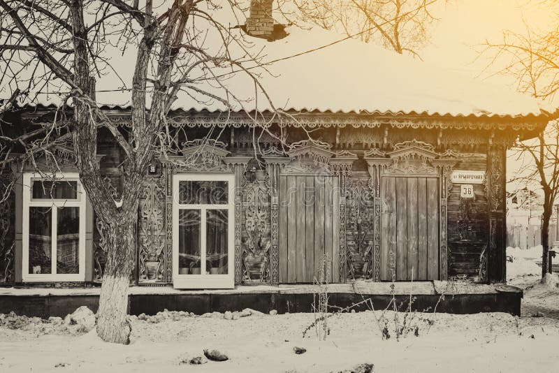 Facade of an old wooden house decorated with carvings in a traditional Russian style, monochrome, blurred image stock photos