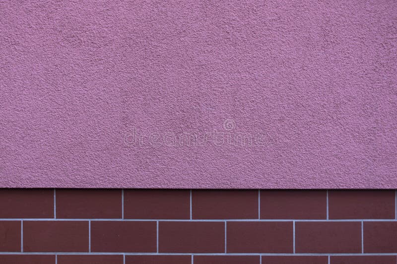 Facade plastered in striking color pink, the base is tiled as a protection against pollution with small, narrow and elongated. Tiles in burgundy, the design is stock photo