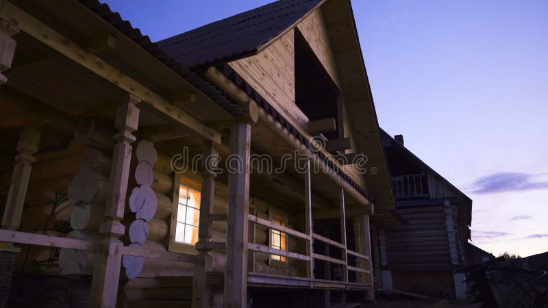 Facade of wooden cottage in Russian style. Stock footage. Bottom view of beautiful wooden cottage outside city in royalty free stock images