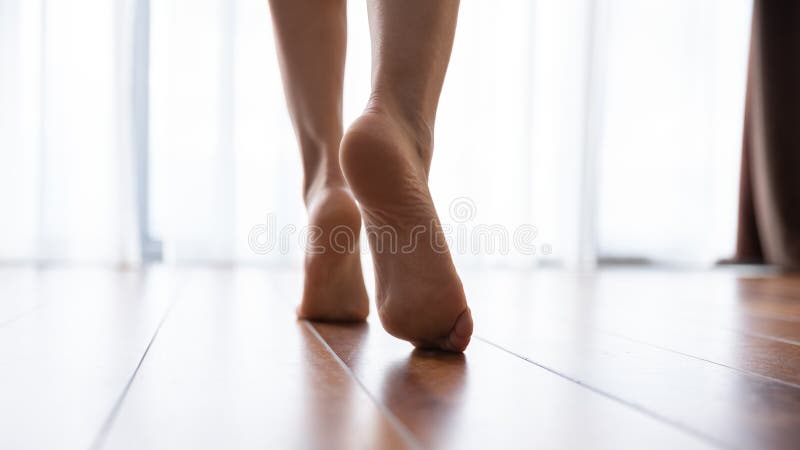 Female feet walking on warm heated floor close up view royalty free stock photography