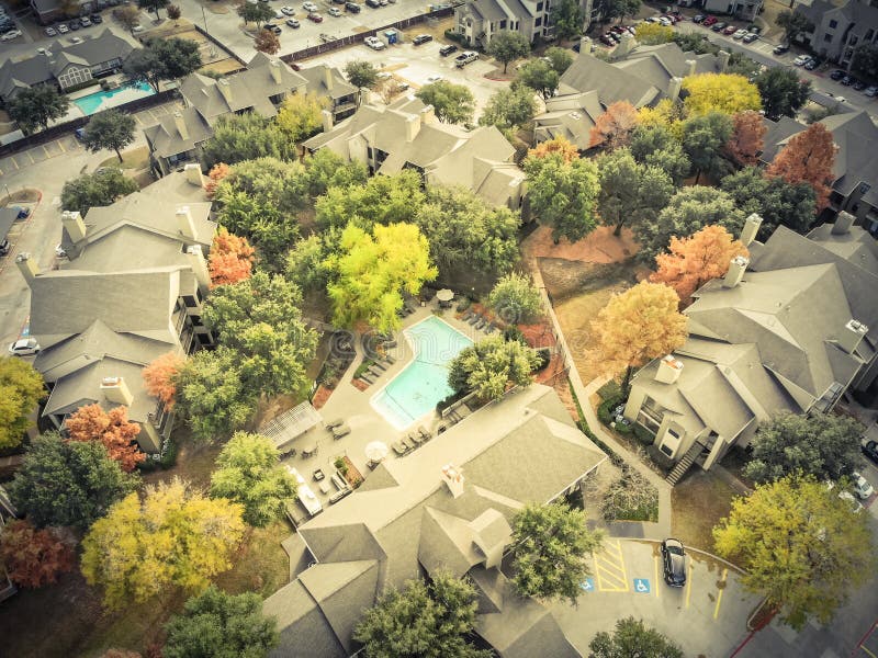 Filtered image aerial view apartment building rental housing sub. Vintage tone aerial view apartment building complex with colorful fall foliage leaves near stock photos