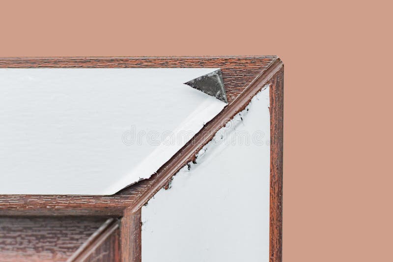 A fragment of plastic Windows with lamination. A fragment of a plastic window with lamination covered with a protective film royalty free stock photography