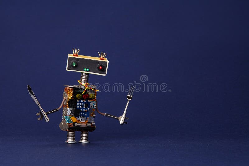 Friendly robot waiter with fork and knife. Food menu concept cute cooking kitchen chef toy character on dark blue stock photography