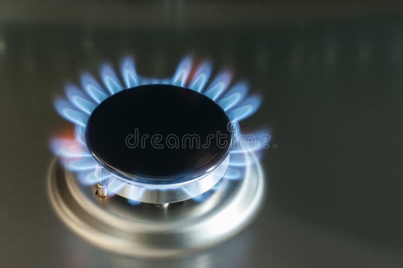 Gas flame of a gas stove. In stainless steel royalty free stock photo