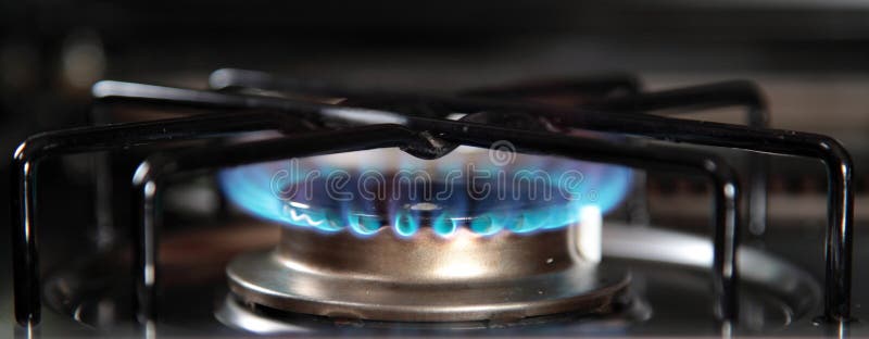 Gas stove. Detail shot of the blue gas flame of a gas stove stock photography