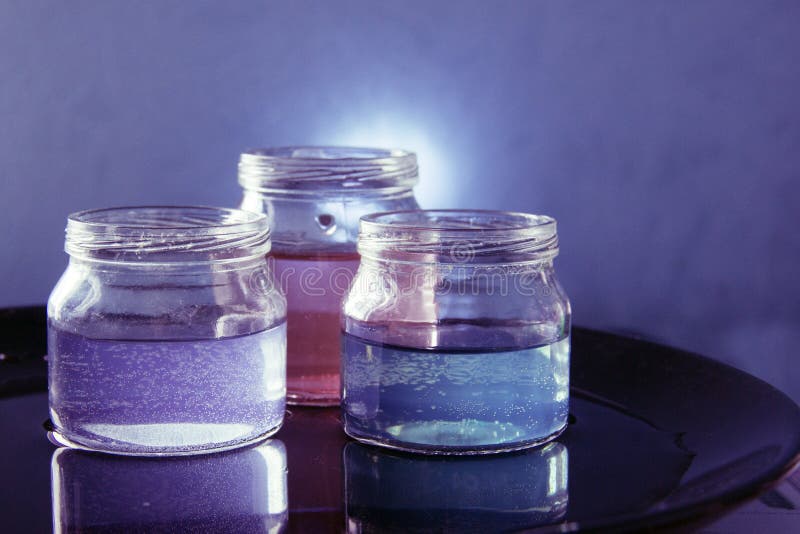 Glass jar with colored liquid royalty free stock photography