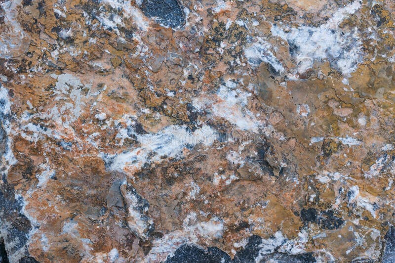 Gray granite texture of the wall with brown paint and peeling plaster royalty free stock images