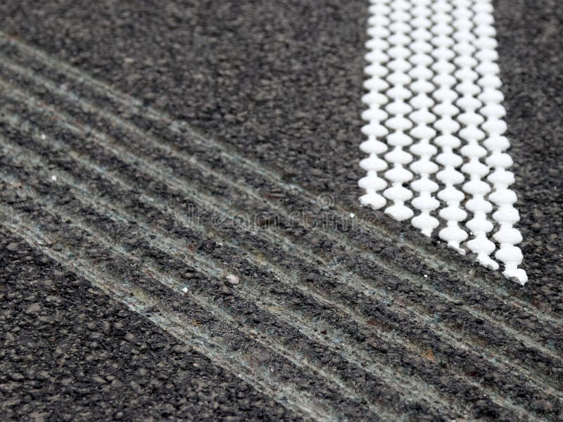 Grouting and hot plastic stripe on asphalt_1. White hot platic stripe on asphalt road stock photography