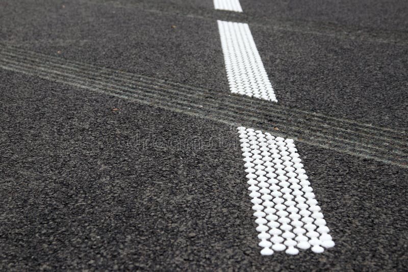 Grouting and hot plastic stripe on asphalt_4. White hot platic stripe on asphalt road royalty free stock photography