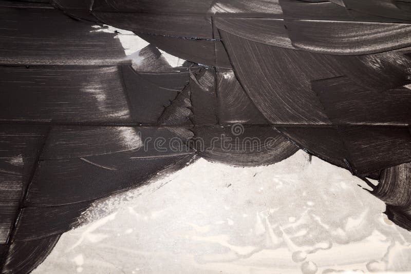 Grouting of light tiles with black grout as background. Layed bathroom tiles being grouted with black mortar as template royalty free stock photo