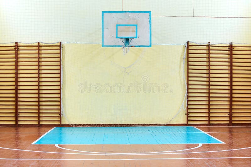 Gym for sports classes at school or College. Swedish wall, stairs, and wooden floor with markings for volleyball.  royalty free stock photo