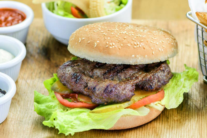 Hamburger. Homemade hamburger made from healthy ingredients at home. Fresh and high-quality ingredients combined with ready-to-eat food on foot. fast food royalty free stock photos