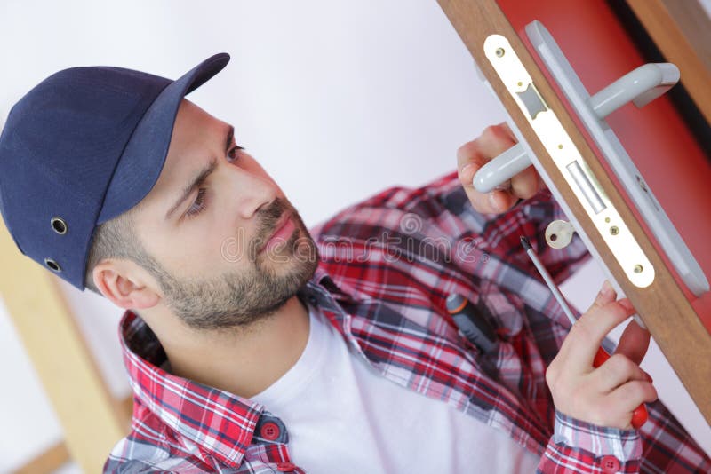 Handyman repair door lock in room royalty free stock photos