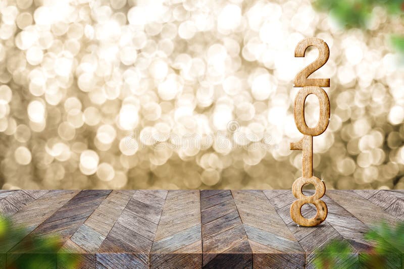 Happy new year 2018 on wood table and blur Christmas tree foreground at blur sparkling gold bokeh light wall,panoramic banner for. Display or montage of product stock photo