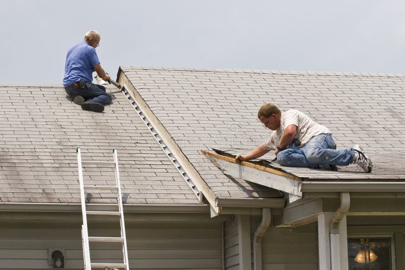 Home repair. Contractor doing repairs on exterior of home rotted wood letting water get into house stock photos