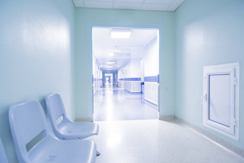 Hospital corridor. Long corridor in hospital with chairs royalty free stock image