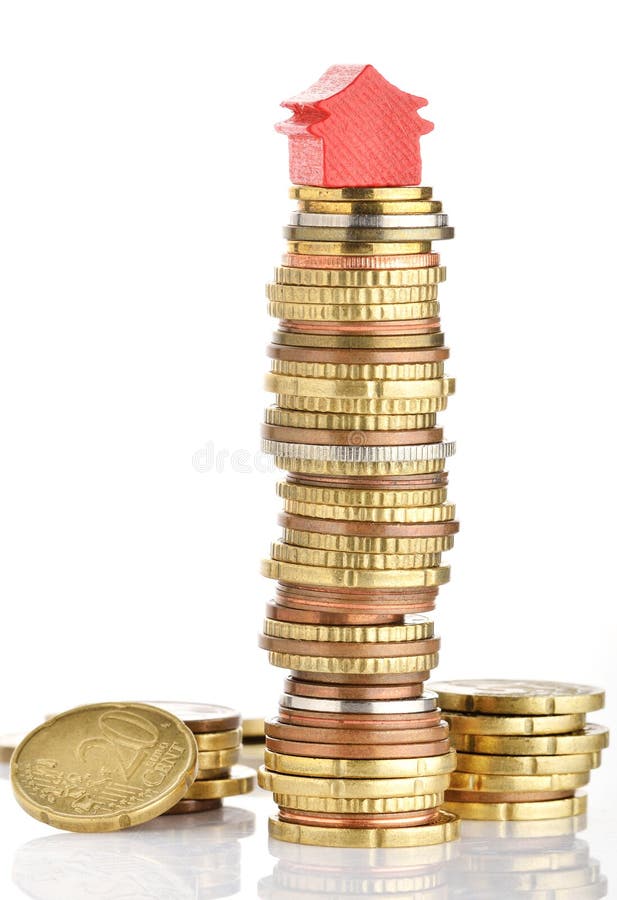 House prices. Model house on a stack of coins representing high prices on real estate market stock image
