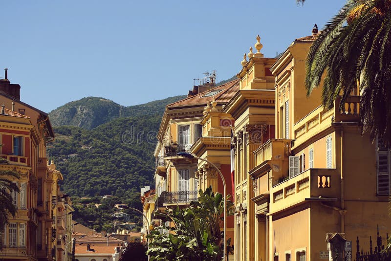 Houses with terracotta plastered facade. Monte Carlo, Monaco - September 21, 2015: beautiful city street with houses with terracotta plastered facade windows and royalty free stock photography