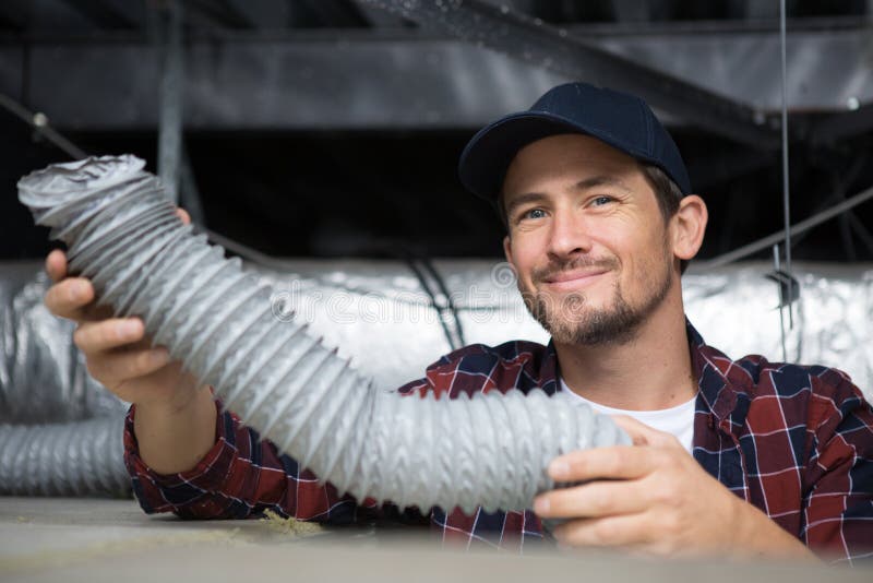 Hvac technician ready to install ventilation system in house royalty free stock photography