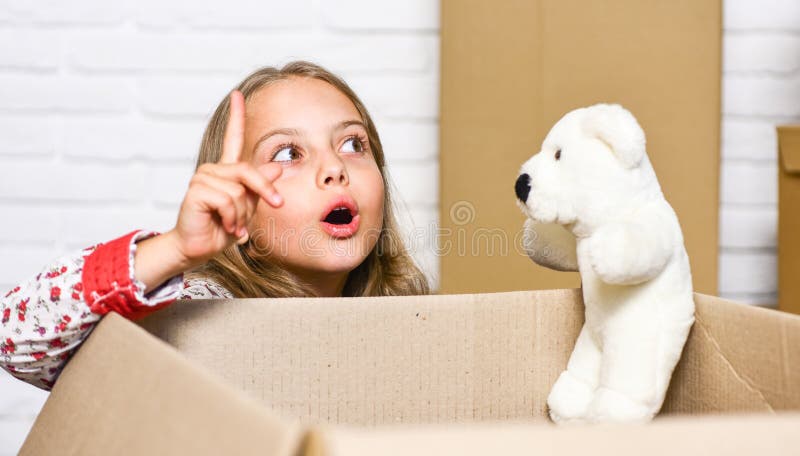 I have an idea. happy child cardboard box. happy little girl with toy. repair of room. new apartment. Cardboard boxes - royalty free stock photo