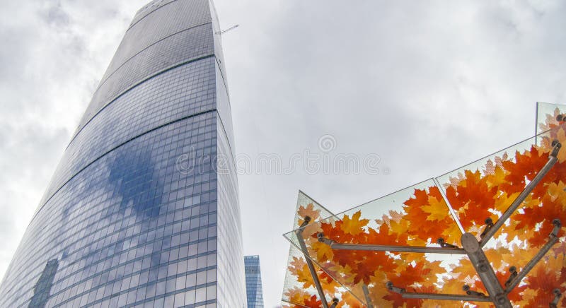 Imitation tree, artificial maple tree with yellow and orange leaves, street decoration, Moscow city, Russia.  stock photos