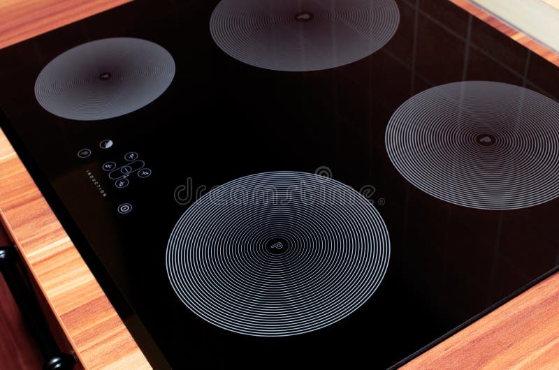 Induction stove. Cooker, embedded in wood furniture stock photos