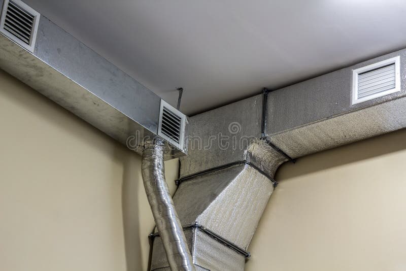 Industrial air duct ventilation equipment and pipe systems installed on industrial building ceiling. stock image